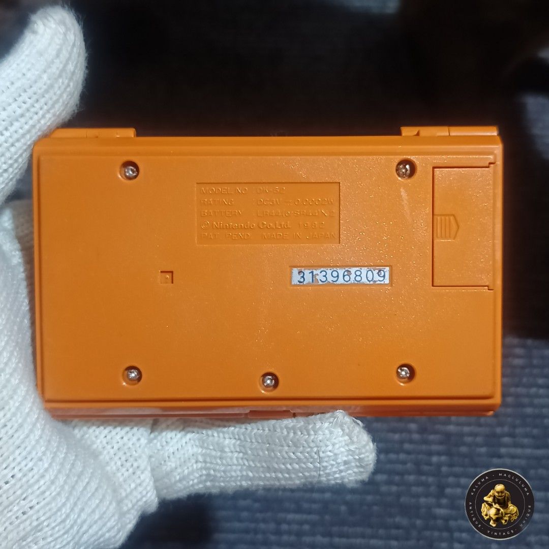 Nintendo Game & Watch Donkey Kong (Category: Nintendo) located in Meycauayan. Submitted by ka_luma (Listing ID 1429926431, Image 3). Description: Selling as is screen burn. For restoration, scrap, parts. Vintage Nintendo Game & Watch Donkey Kong multi screen handheld game. Features the classic Donkey Kong game with two screens. Includes the controller, start, and jump buttons. The game has a bright orange casing with the Nintendo logo. The back o