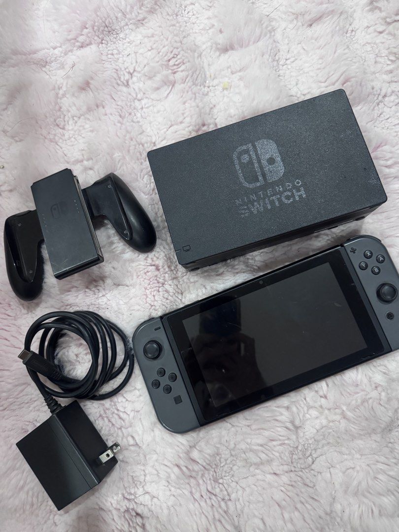 Nintendo Switch v1 (Category: Nintendo) located in Manila. Submitted by sophianac48808 (Listing ID 1430004211, Image 1). Description: Switch v1 (PHP6,500) Inclusions - original charger - dock - joycon grip - case Issues: The controllers have joycon drift and the unit itself has signs of use. Scratches on screen protector.