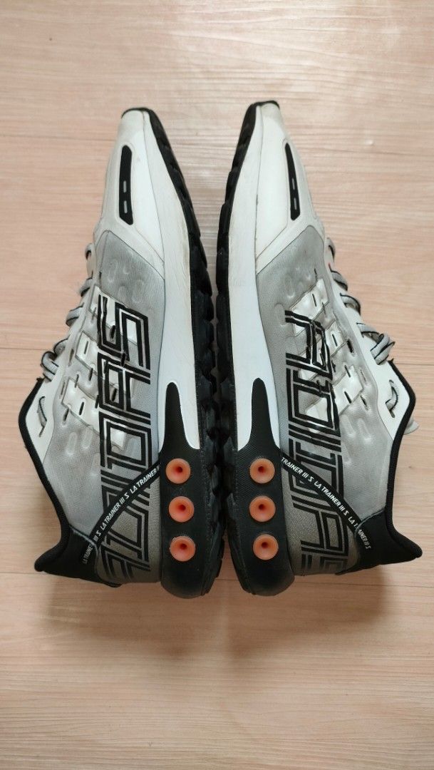 preloved Adidas LA Trainer Sneakers - size 10 (Category: Sneakers) located in Mandaluyong City. Submitted by itscris28 (Listing ID 1429932526, Image 3). Description: - Adidas LA Trainer sneakers in a grey and black colorway - Features the Adidas logo on the tongue and heel - The shoes have a mesh upper and a rubber sole - The size tag is visible inside the shoe - The shoes have a unique design with orange accents on the sole - size 10 - men's sho