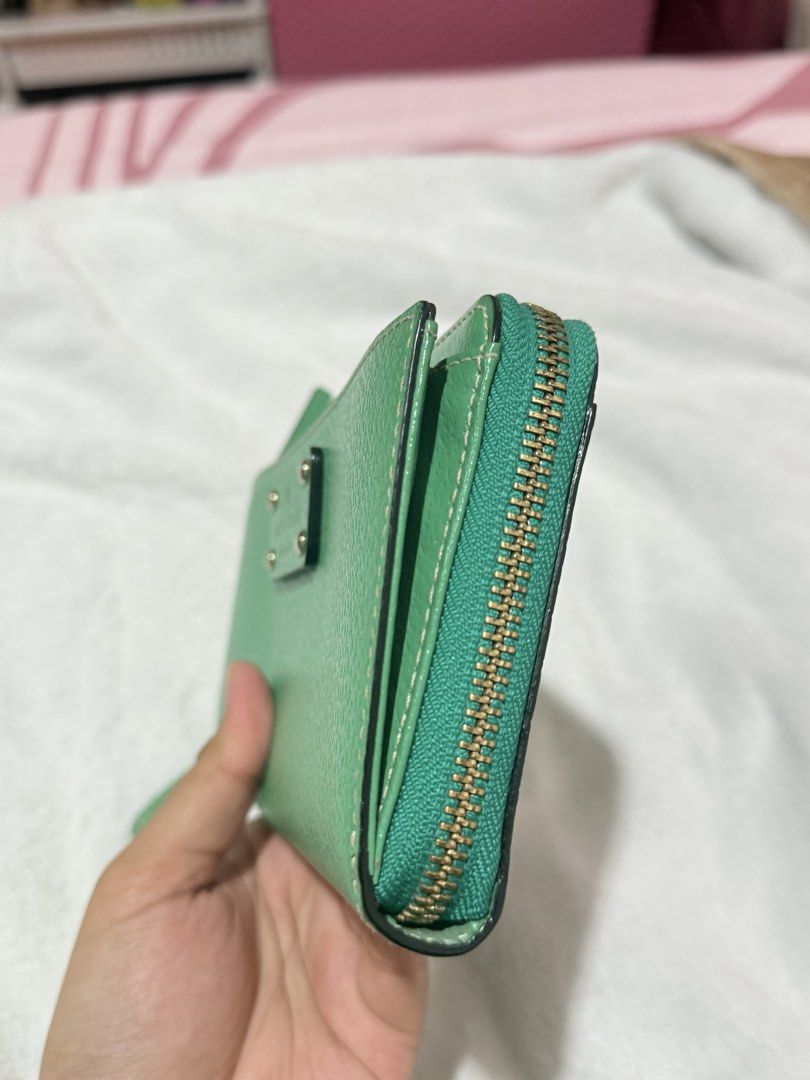 Preloved Kate Spade Green Wristlet Wallet (Category: Wallets & Card holders) located in Imus. Submitted by kmdf22 (Listing ID 1429966024, Image 3). Description: preloved long wallet !! 🕶️ rfs: decluttering condition: 5/10 — has some visible signs of usage but still in a good condition 💲 price is still SLIGHTLY negotiable for sure buyers! 📍 imus, cavite 🤝🏻 can do meetups around imus/dasma/bacoor 🏍️ delivery fee to be shouldered by BUYER .