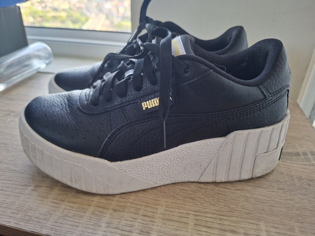Puma Cali Wedge Black Sneakers (Category: Sneakers) located in Pasig City. Submitted by zmabel (Listing ID 1430016932, Image 1). Description: Fits 24.5cm wide feet well. Worn few times, kept in storage. Can use cleaning. RFS: Decluttering Delivery fee via grab/lala/etc to be shouldered by the buyer..