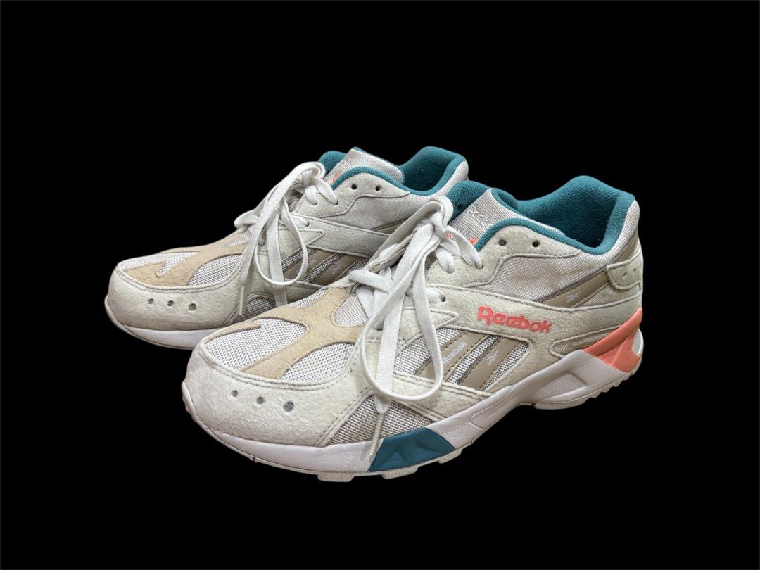 Reebok Aztrek Running Shoes (Category: Sneakers) located in Pasig City. Submitted by peter_german (Listing ID 1430011811, Image 1). Description: Clean white pair with teal and coral accents, sporty silhouette, and nice overall look. Minor signs of use but still very presentable and easy to style. Issue: pair has a slight outsole opening/separation, but it is only minor and not very noticeable. No inclusions. .
