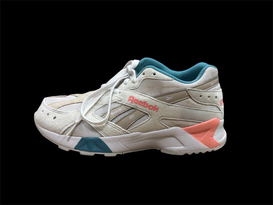 Reebok Aztrek Running Shoes (Category: Sneakers) located in Pasig City. Submitted by peter_german (Listing ID 1430011811, Image 3). Description: Clean white pair with teal and coral accents, sporty silhouette, and nice overall look. Minor signs of use but still very presentable and easy to style. Issue: pair has a slight outsole opening/separation, but it is only minor and not very noticeable. No inclusions. .