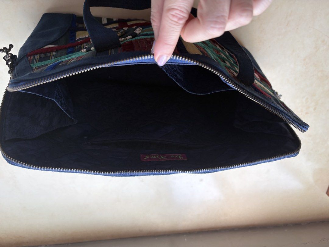 Unique Patchwork Handbag (Category: Shoulder Bags) located in Singapore. Submitted by green.apple7 (Listing ID 1429852286, Image 3). Description: Hand made patchwork handbag with a unique design. Features a zip closure and sturdy handles. The interior is lined with a dark fabric. Includes decorative charms on the zipper. A great statement piece! Dimensions L36cm H 25cm W 12cm.