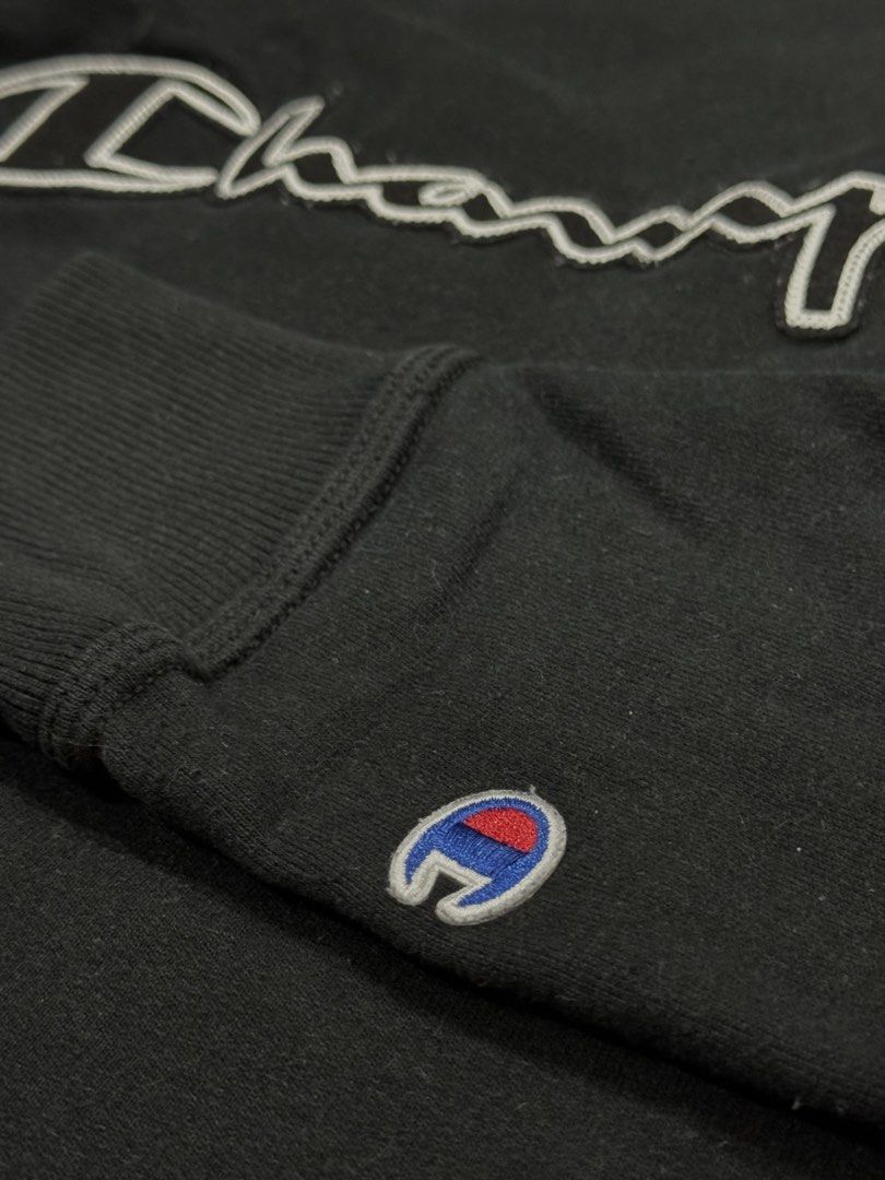 Unisex Champion Black Sweatshirt (Category: Coats, Jackets and Outerwear) located in Pasig City. Submitted by peter_german (Listing ID 1430013055, Image 2). Description: Champion sweatshirt in good condition. Black with front logo and sleeve patch. Clean, simple, and easy to wear. W: 20 inches L: 26 inches.