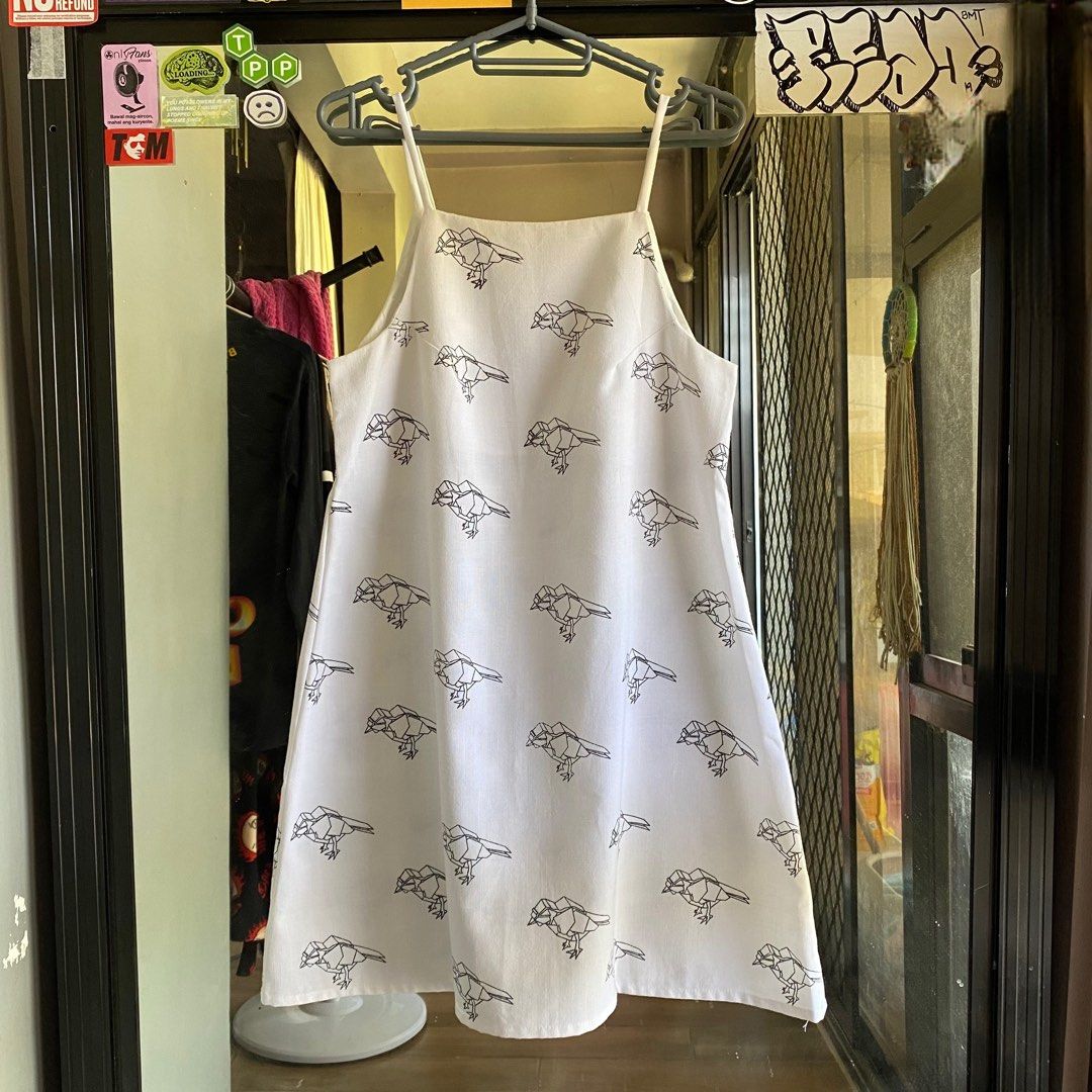 Canvas bird print dress (Category: Dresses) located in Imus. Submitted by shesleavinghome (Listing ID 1429947139, Image 3). Description: White canvas dress with bird print. Features a halter neckline and straps. The dress has a simple, A-line silhouette in canvas cotton fabric. With inner lining. Fits small to medium Message for more details Thank you!.