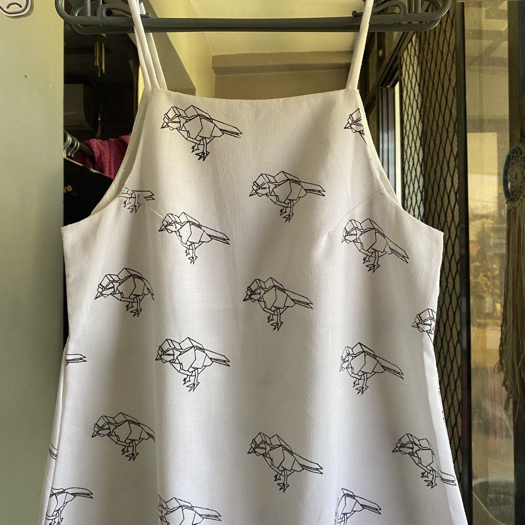 Canvas bird print dress (Category: Dresses) located in Imus. Submitted by shesleavinghome (Listing ID 1429947139, Image 1). Description: White canvas dress with bird print. Features a halter neckline and straps. The dress has a simple, A-line silhouette in canvas cotton fabric. With inner lining. Fits small to medium Message for more details Thank you!.