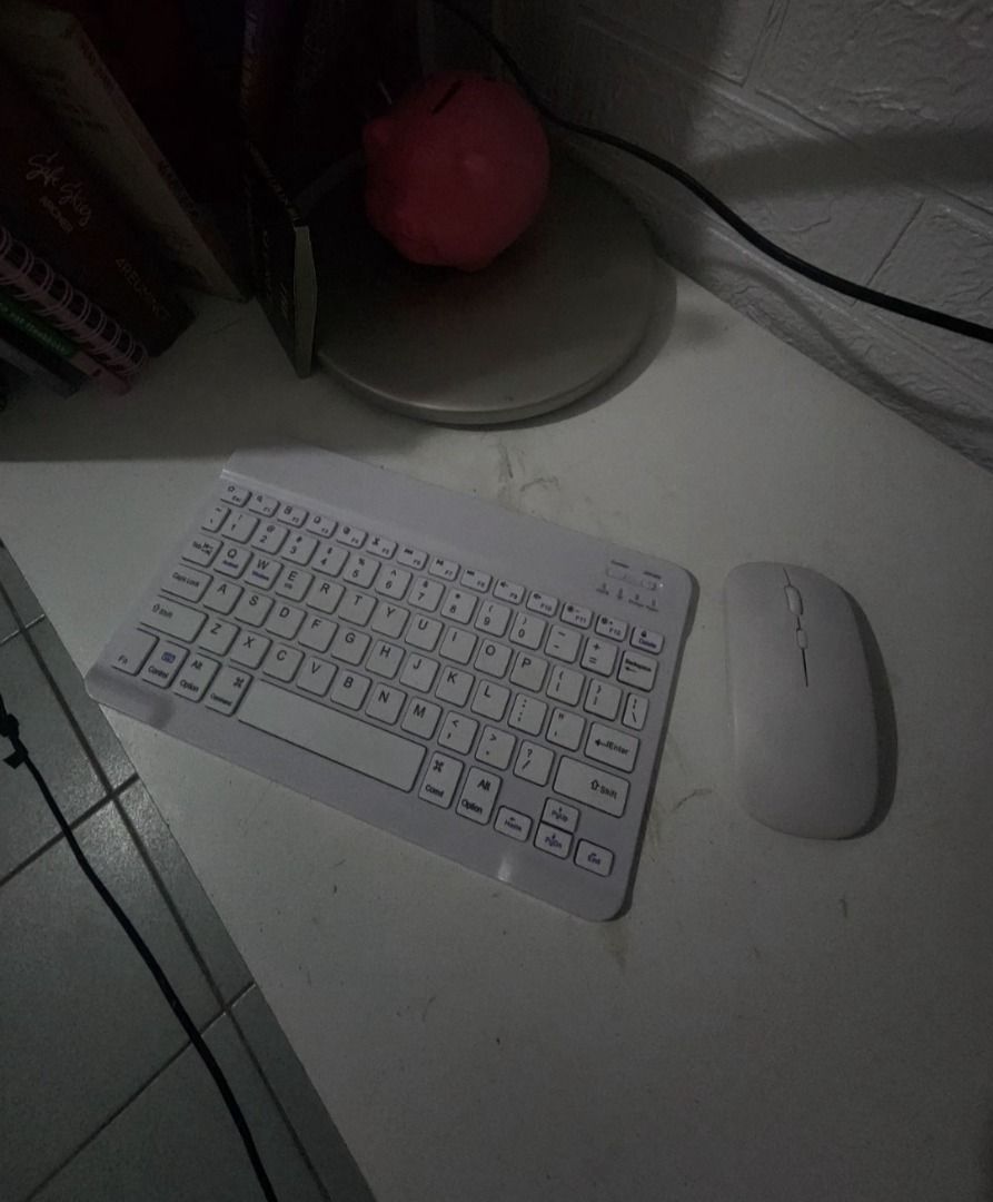 Wireless Keyboard and Mouse Set (Category: Computer Keyboard) located in Manila. Submitted by ashcreamstore (Listing ID 1429959410, Image 1). Description: White wireless keyboard and mouse set. The keyboard has a standard layout with a number pad and function keys. The mouse is a simple, ergonomic design. Perfect for a home office or on-the-go use. Magaan yung keyboard and mouse pwede dalhin kahit saan. RFS: hindi nagagamit Please manage your exp