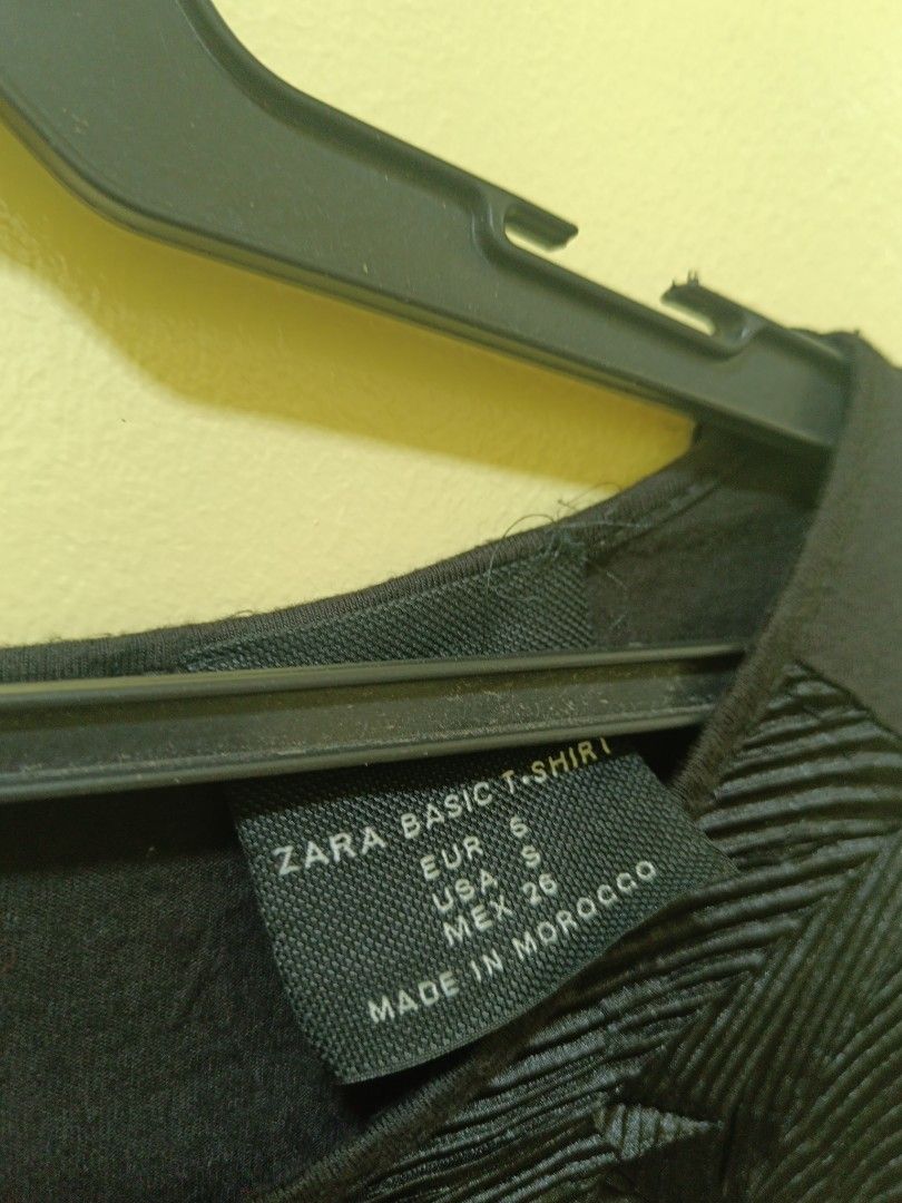Zara Basic T-Shirt Dress (Category: Dresses) located in Trece Martires City. Submitted by declutterbyedi (Listing ID 1429983170, Image 2). Description: Black dress from Zara. Features a textured design. The dress has a round neckline and short sleeves. The size is S, and it is made in Morocco. A versatile piece suitable for various occasions..