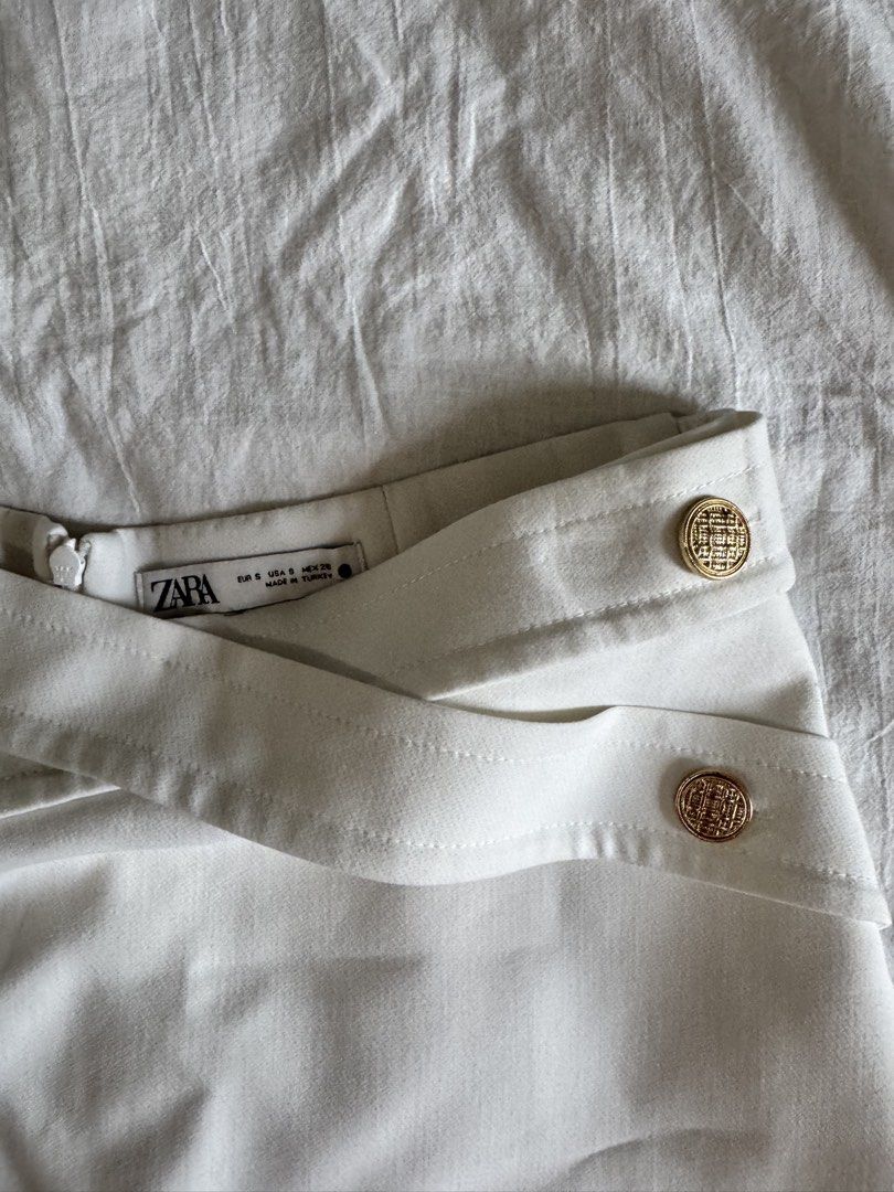 Zara White Shorts with Gold Buttons (Category: Shorts) located in Taguig. Submitted by celaenaaa (Listing ID 1430000626, Image 2). Description: Minimal signs of usage at the back of the waistband Size small but best fits medium See measurements in the photo Loc: Legazpi, Makati.