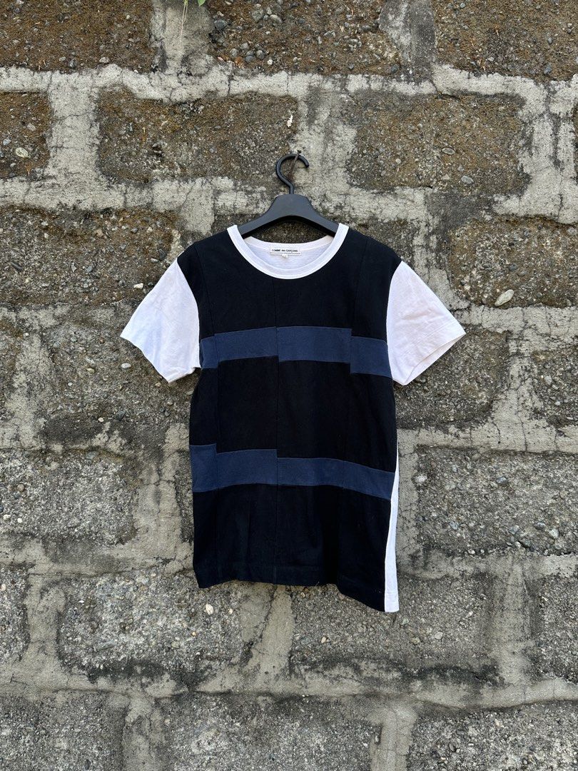ARCHIVE: Comme des Garçons Patchwork Panel Tee (Category: Luxury Apparel) located in Urdaneta. Submitted by redeemedcollective (Listing ID 1435286500, Image 2). Description: An authentic archival tee from the Comme des Garçons main line. Features the brand’s signature deconstructed aesthetic with asymmetrical patchwork paneling in black, navy, and white. THE DETAILS • Design: Multi-tonal block construction with mismatched sleeves and side panels.