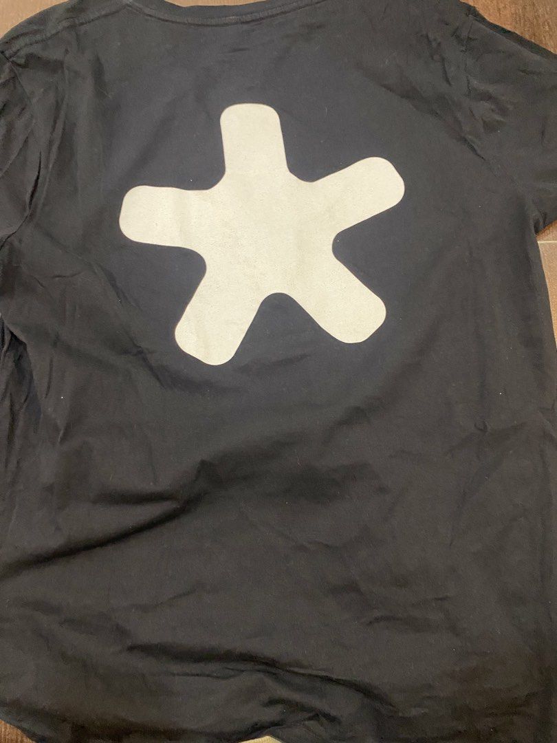 Beabadoobee Black Graphic T-shirt (Category: Tshirts & Polo Shirts ) located in Imus. Submitted by mnmv23 (Listing ID 1435280550, Image 2). Description: - Black crew neck t-shirt - Features a white "beabadoobee" graphic on the front - Includes a white star-shaped graphic on the back.