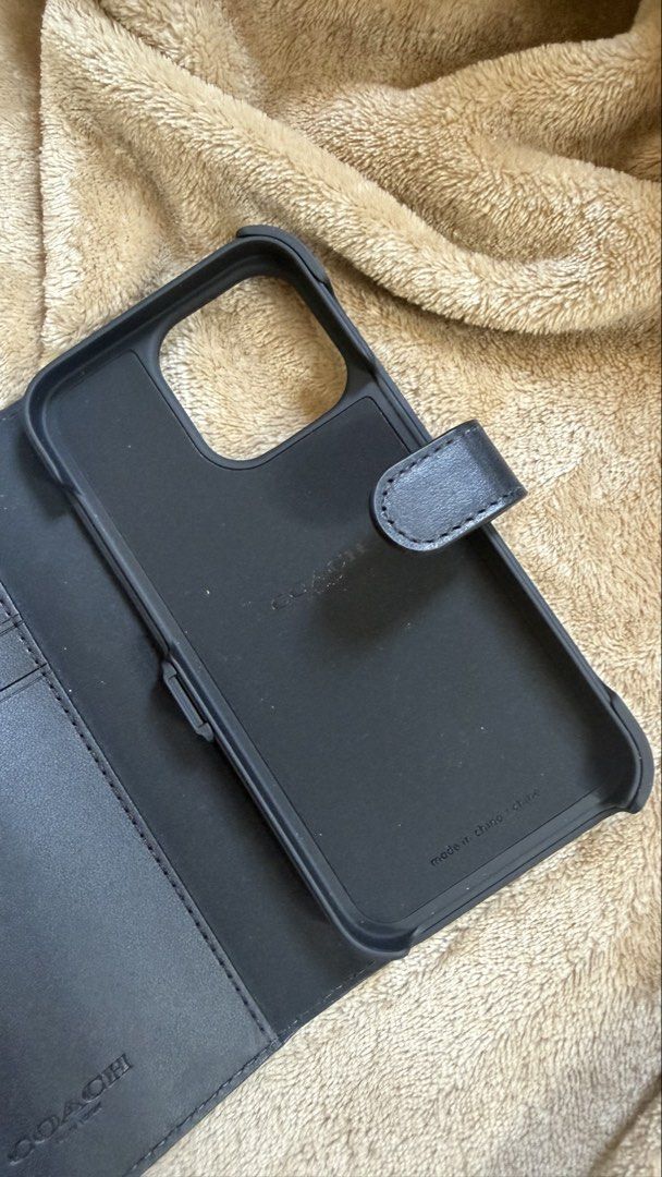 Coach New York iPhone 13/13 Pro Case (Category: Cases & Sleeves) located in Valenzuela. Submitted by ashsupr3macy (Listing ID 1435221927, Image 3). Description: Product Description: - Compatible with iPhone 13 and 13 Pro - Detachable design - Features card slots - Made of genuine leather - Secure magnetic closure - Comes in original packaging Just hit me a message if you need more pictures of the product.