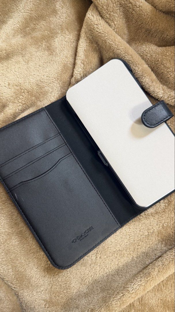Coach New York iPhone 13/13 Pro Case (Category: Cases & Sleeves) located in Valenzuela. Submitted by ashsupr3macy (Listing ID 1435221927, Image 2). Description: Product Description: - Compatible with iPhone 13 and 13 Pro - Detachable design - Features card slots - Made of genuine leather - Secure magnetic closure - Comes in original packaging Just hit me a message if you need more pictures of the product.