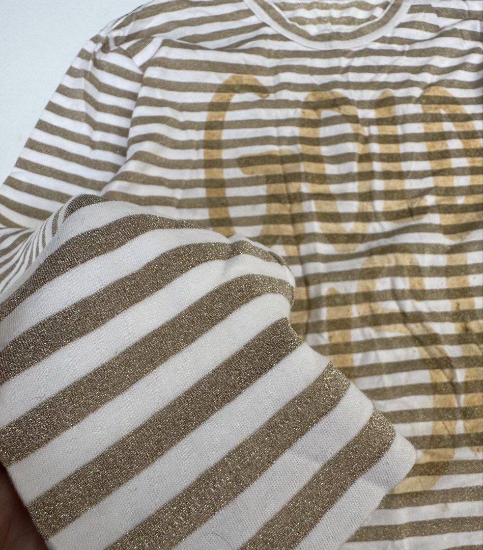 Comme des Garcons - Glittered Gold Rush Longsleeves (Category: Longsleeves) located in Caloocan City. Submitted by opulent.finds (Listing ID 1435241810, Image 3). Description: Medium on tag (unisex) Width: 20” Lenght: 28” 9/10 condition Flaw: faded print, still in good condition.