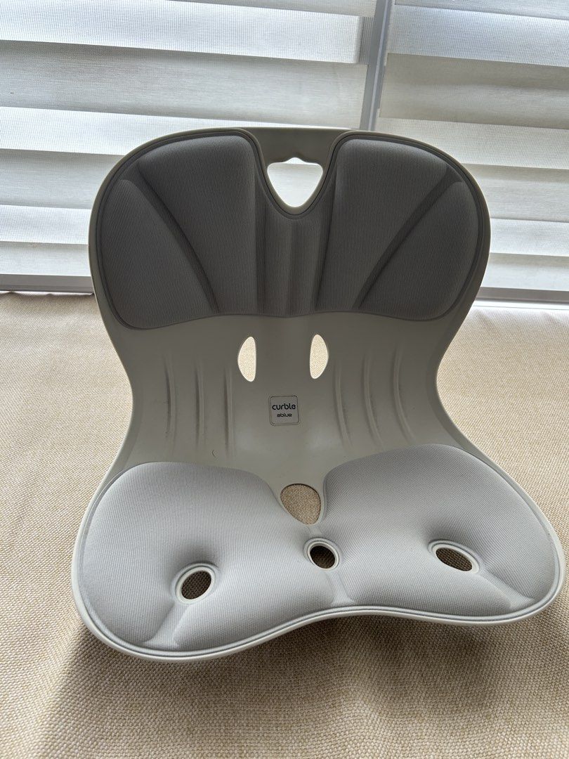 Curble Posture Corrector (Category: Braces, Support & Protection) located in Manila. Submitted by astrogirl911 (Listing ID 1435200660, Image 1). Description: - Curble posture corrector for improved posture. - Light gray color. - Contoured design for comfort. - Padded seating areas. - Curved shape with carrying hole. - Features the Curble brand logo..