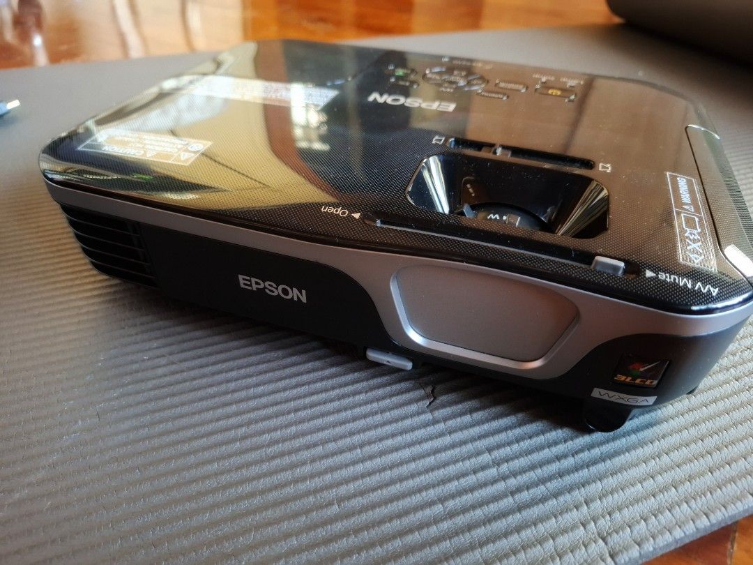 Epson EX7210 Projector (Category: Projectors) located in Makati City. Submitted by itemsforless2025 (Listing ID 1435195705, Image 1). Description: - Epson EX7210 projector - Includes power cable and additional cable - Multiple input ports: HDMI, VGA, RCA - Stylish black and silver design - Serial number: PRVK1Y01195 #carousave2026.