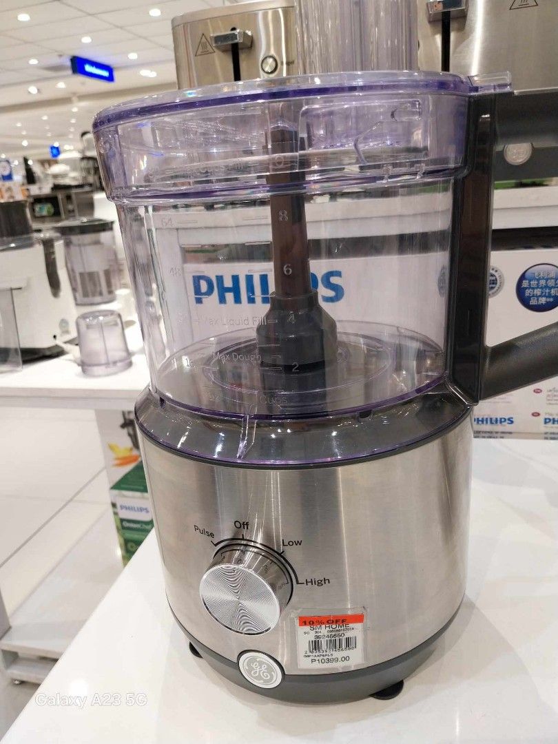 GE 12-Cup Food Processor (Category: Weaning & Toddler Feeding) located in Pasig City. Submitted by rare.ashima25 (Listing ID 1426121876, Image 2). Description: GE food processor is a 12-cup capacity appliance. It comes with multiple blades and attachments, all appearing to be new and unused. The unit has a silver finish and a clear bowl. The box is included. It is designed for various food preparation tasks..