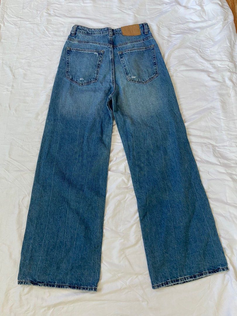H&M (DIVIDED) - Wide Leg Jeans (Category: Jeans) located in Legazpi City. Submitted by clutterbusterph (Listing ID 1435280466, Image 2). Description: SURE BUYERS ONLY measurements: waist: 26 inches hips: 32 inches length: 41.5 inches - Light blue wash - Distressed details - High-waisted - Relaxed wide-leg fit - Button and zipper closure.