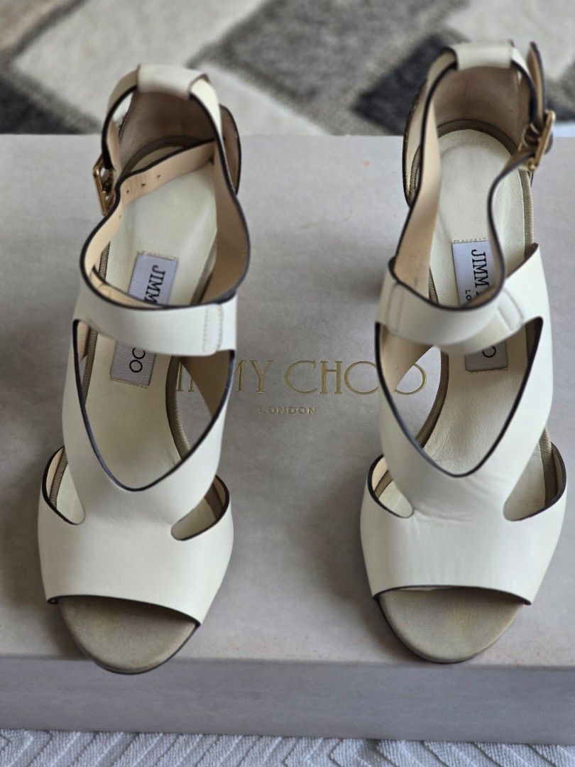 Jimmy Choo White Leather Sandals (Category: Flats & Sandals) located in Santa Rosa. Submitted by brightstar2212 (Listing ID 1435179595, Image 3). Description: - Jimmy Choo sandals - White leather - Brown heel - Gold accents - Original box included - Strap closure - Adds luxury to any outfit.