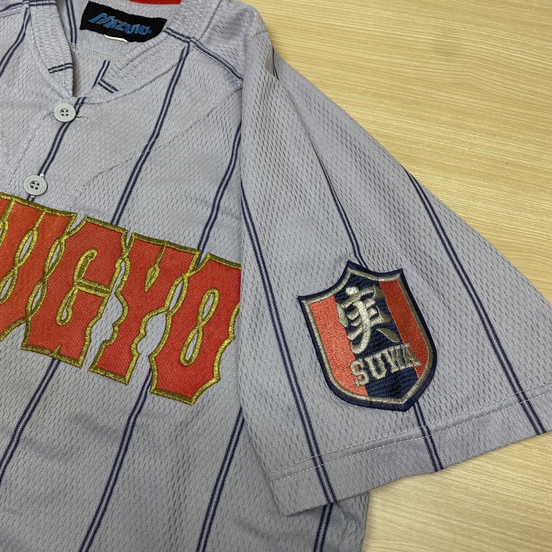 Jitsugyo Baseball Jersey (Category: Activewear) located in Navotas City. Submitted by jericafits (Listing ID 1435268753, Image 3). Description: • Mizuno Jitsugyo Baseball Jersey 📏 Size: L 📏 Dimes: 20.5 x 29 - 31.5 ₱ 399 + sf - Baseball jersey - Features "Jitsugyo" embroidery - Striped pattern - Red collar - Sleeve patch - Button-up front - Short sleeves - Plain back with vertical stripes - Tag visible.