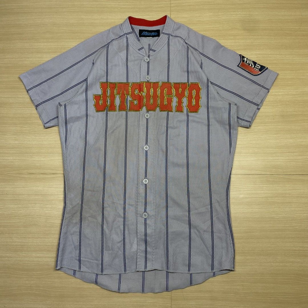 Jitsugyo Baseball Jersey (Category: Activewear) located in Navotas City. Submitted by jericafits (Listing ID 1435268753, Image 1). Description: • Mizuno Jitsugyo Baseball Jersey 📏 Size: L 📏 Dimes: 20.5 x 29 - 31.5 ₱ 399 + sf - Baseball jersey - Features "Jitsugyo" embroidery - Striped pattern - Red collar - Sleeve patch - Button-up front - Short sleeves - Plain back with vertical stripes - Tag visible.