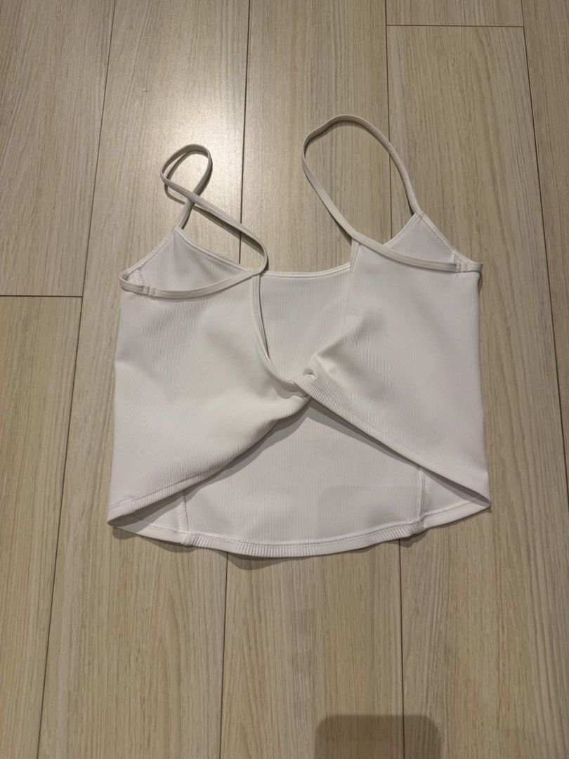 Lululemon Ribbed Crop Top with Tie on the Back (Category: Sleeveless) located in Mandaluyong City. Submitted by justsomeofmythings_ (Listing ID 1435214937, Image 2). Description: - White crop top - Ribbed texture - V-neck design - Thin straps - Twisted back detail - Stretchy material - Pairs well with various bottoms.