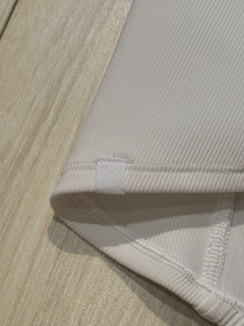 Lululemon Ribbed Crop Top with Tie on the Back (Category: Sleeveless) located in Mandaluyong City. Submitted by justsomeofmythings_ (Listing ID 1435214937, Image 3). Description: - White crop top - Ribbed texture - V-neck design - Thin straps - Twisted back detail - Stretchy material - Pairs well with various bottoms.