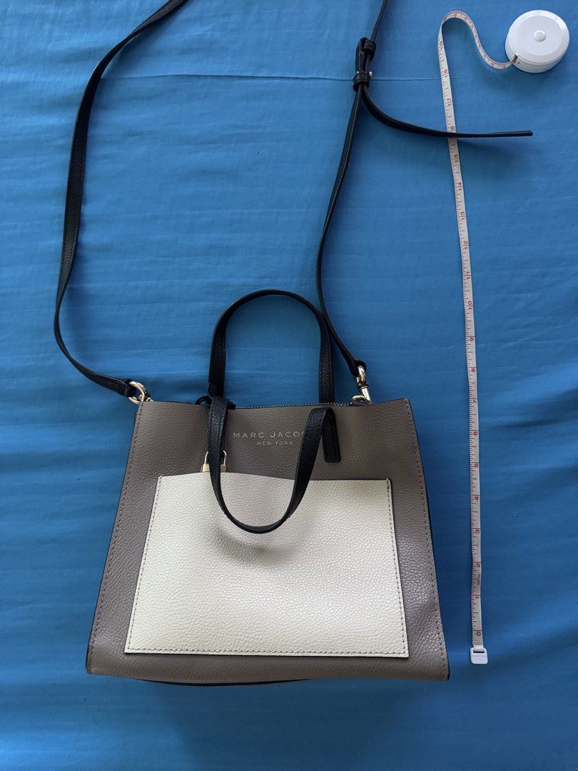 Marc Jacobs New York Handbag (Category: Luxury Bags & Wallets) located in Antipolo. Submitted by chleascloset (Listing ID 1435190157, Image 1). Description: - Marc Jacobs Women's Grind Colorbloack Mini Tote Bag - Top handle and detachable shoulder strap - Features front pocket and spacious interior - Color combination: Taupe, white, and black - Suitable for everyday use and special occasions -bought from USA.