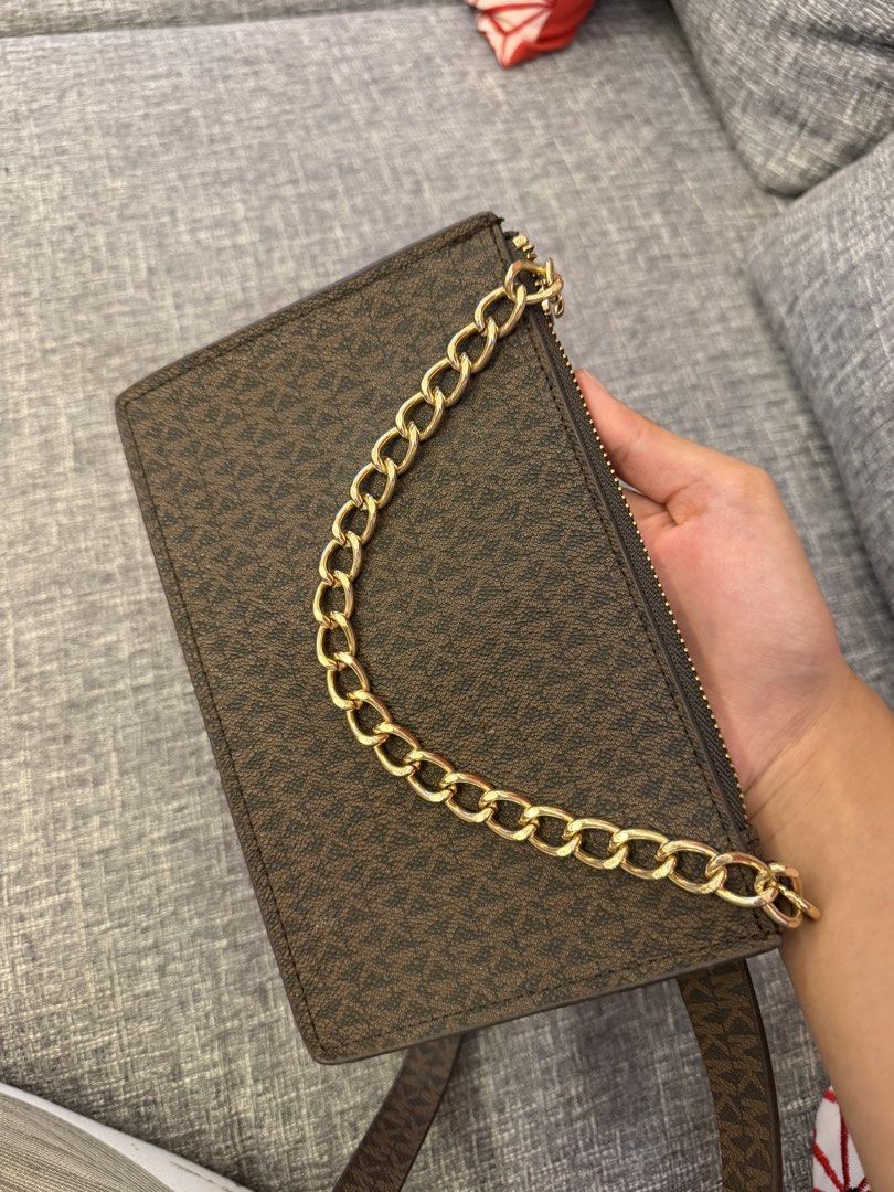 Michael Kors Belt Bag with Chain (Category: Luxury Bags & Wallets) located in San Jose. Submitted by affordabletrendsby_cai (Listing ID 1435179628, Image 3). Description: - Michael Kors belt bag - Brown monogram pattern - Gold chain detail - Matching brown belt - Rectangular shape - Zipper closure - Made with synthetic materials - Original price: "$55".
