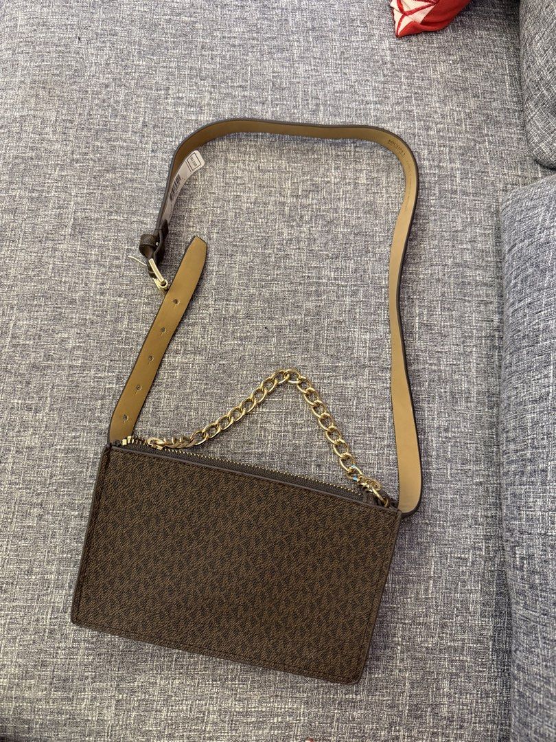 Michael Kors Belt Bag with Chain (Category: Luxury Bags & Wallets) located in San Jose. Submitted by affordabletrendsby_cai (Listing ID 1435179628, Image 2). Description: - Michael Kors belt bag - Brown monogram pattern - Gold chain detail - Matching brown belt - Rectangular shape - Zipper closure - Made with synthetic materials - Original price: "$55".