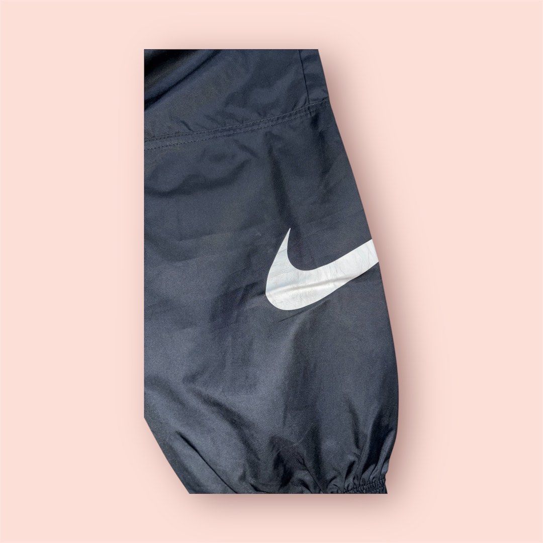 Nike Track Pants (Category: Joggers) located in Rosario. Submitted by preloveditems2002 (Listing ID 1435219787, Image 3). Description: - Black Nike track pants - White swoosh logo - Elastic waistband and cuffs - Unique mesh panel design - Perfect for workouts or casual wear - Comfortable and stylish.