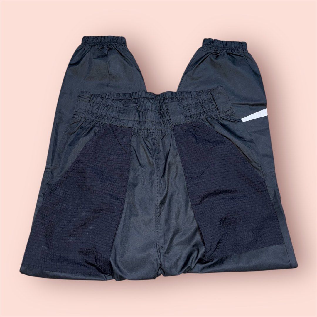 Nike Track Pants (Category: Joggers) located in Rosario. Submitted by preloveditems2002 (Listing ID 1435219787, Image 1). Description: - Black Nike track pants - White swoosh logo - Elastic waistband and cuffs - Unique mesh panel design - Perfect for workouts or casual wear - Comfortable and stylish.
