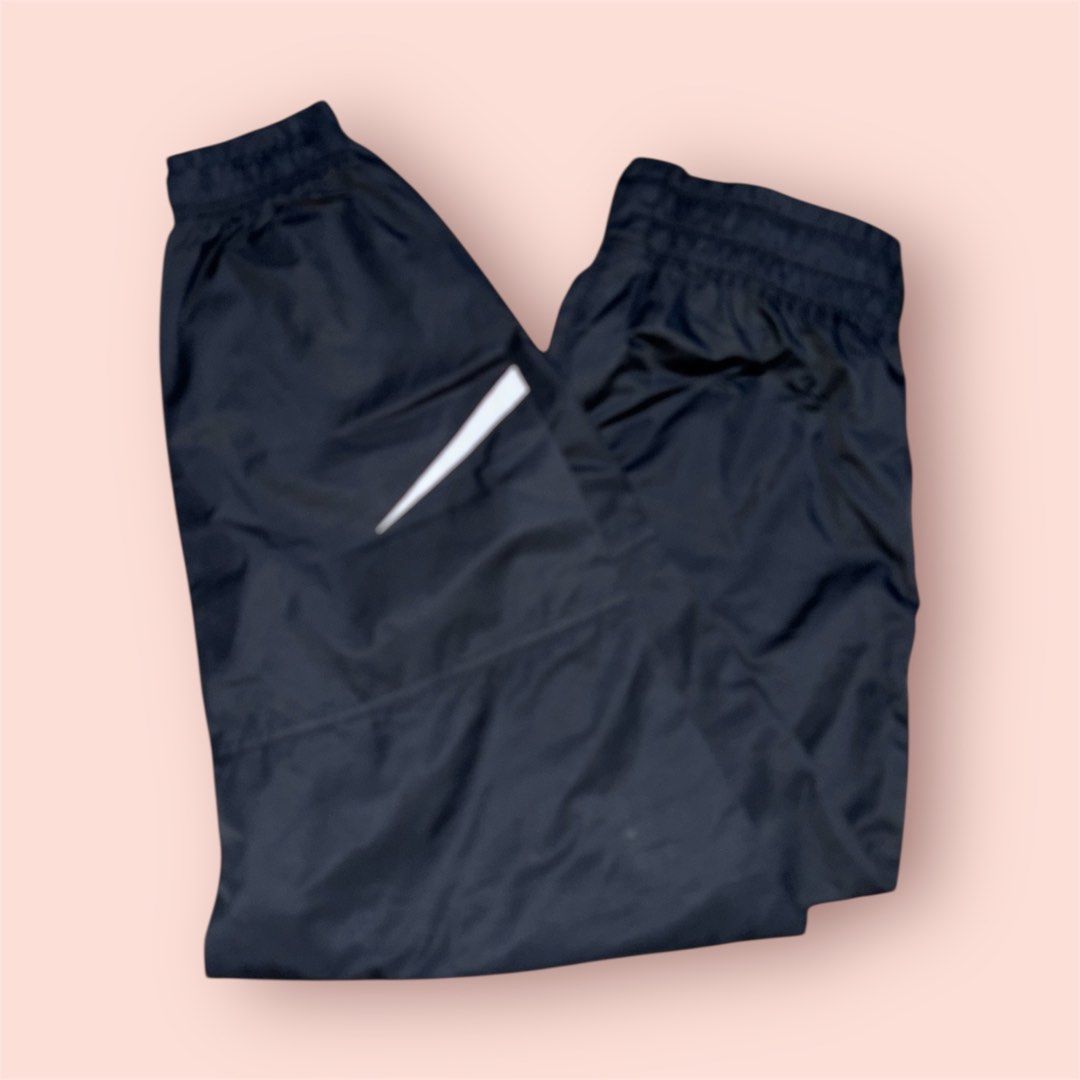 Nike Track Pants (Category: Joggers) located in Rosario. Submitted by preloveditems2002 (Listing ID 1435219787, Image 2). Description: - Black Nike track pants - White swoosh logo - Elastic waistband and cuffs - Unique mesh panel design - Perfect for workouts or casual wear - Comfortable and stylish.