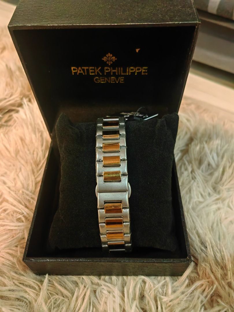 Patek Philippe Geneve Watch (Category: Luxury Watches) located in Cebu City. Submitted by esrpreloved (Listing ID 1435218483, Image 3). Description: - Patek Philippe watch - Features a gold and silver-toned band - Elegant gold-colored face - Includes original black box with Patek Philippe Geneve logo - Date display function - Original tag still attached - A stylish and sophisticated accessory.
