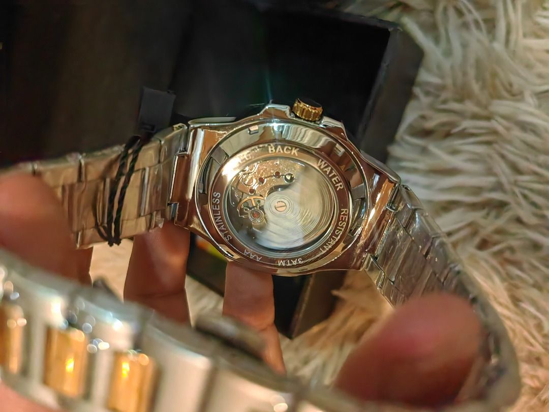 Patek Philippe Geneve Watch (Category: Luxury Watches) located in Cebu City. Submitted by esrpreloved (Listing ID 1435218483, Image 2). Description: - Patek Philippe watch - Features a gold and silver-toned band - Elegant gold-colored face - Includes original black box with Patek Philippe Geneve logo - Date display function - Original tag still attached - A stylish and sophisticated accessory.