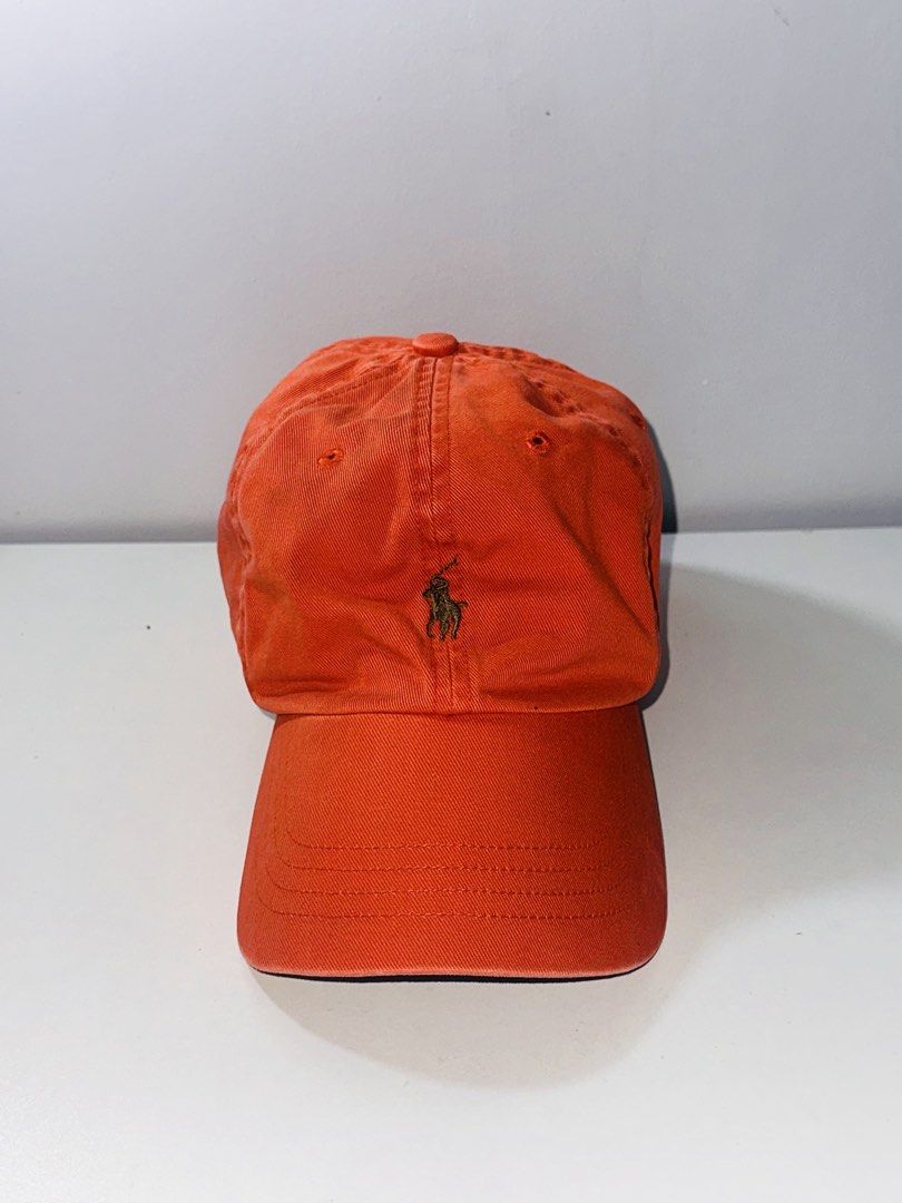Polo Ralph Lauren Leatherstrap Ball Cap Orange Dadhat (Category: Caps & Hats) located in Santa Barbara. Submitted by marcaws (Listing ID 1432943618, Image 1). Description: - Authentic Polo Ralph Lauren cap - Color: Orange 🍊 colorway / Dark Green Pony - Color rate: 9/10 - Vintage Leatherstrap back - Size: Adult size -Condition: Excellent - No issues.