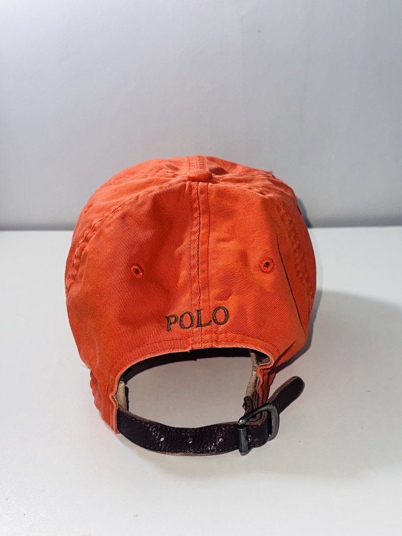 Polo Ralph Lauren Leatherstrap Ball Cap Orange Dadhat (Category: Caps & Hats) located in Santa Barbara. Submitted by marcaws (Listing ID 1432943618, Image 2). Description: - Authentic Polo Ralph Lauren cap - Color: Orange 🍊 colorway / Dark Green Pony - Color rate: 9/10 - Vintage Leatherstrap back - Size: Adult size -Condition: Excellent - No issues.