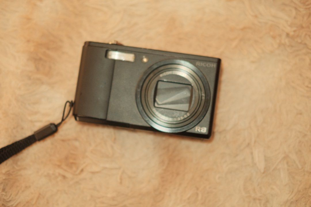 Ricoh R8 Digital Camera (Category: Cameras) located in Valenzuela. Submitted by pehpnd_ (Listing ID 1435173598, Image 3). Description: - Ricoh R8 digital camera - Black body - Zoom lens - Built-in flash - In good working condition Sample photos provided Honest issues: Some missing crews but the body is still intact Minimal scratches (sign of usage) Has a black dot appearing in the photos sometimes but not all the time (you can check it on the sam