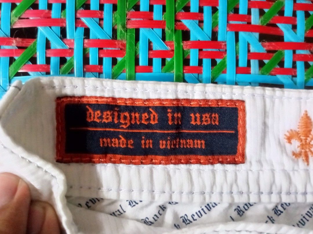 Rock Revival White Denim Shorts (Category: Shorts) located in Manila. Submitted by xthirft_finderx (Listing ID 1435200215, Image 3). Description: - Rock Revival white denim shorts - Button closure - Multiple pockets - Made of 100% cotton - Machine wash separately in cold water - Stylish design with decorative stitching - Features the Rock Revival logo - Designed in the USA, made in Vietnam.