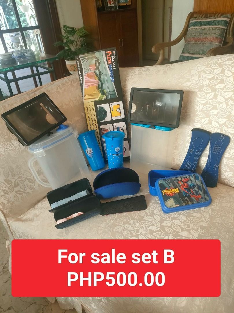 Set B: Food Storage, Tumblers, Hanger, Pitcher (Category: Other Kitchenware & Tableware) located in Caloocan City. Submitted by rise-edge (Listing ID 1435204039, Image 1). Description: - Food storage container - 2 Nestle Choco Milk tumblers - Flexi Hanger - Water pitcher - Pair of blue Spoon and Fork cases - Spider-Man lunchbox (Well Used) - Mobile Screen Enlarger - Eye Glasses Cases Selling all items for PHP500.00!.