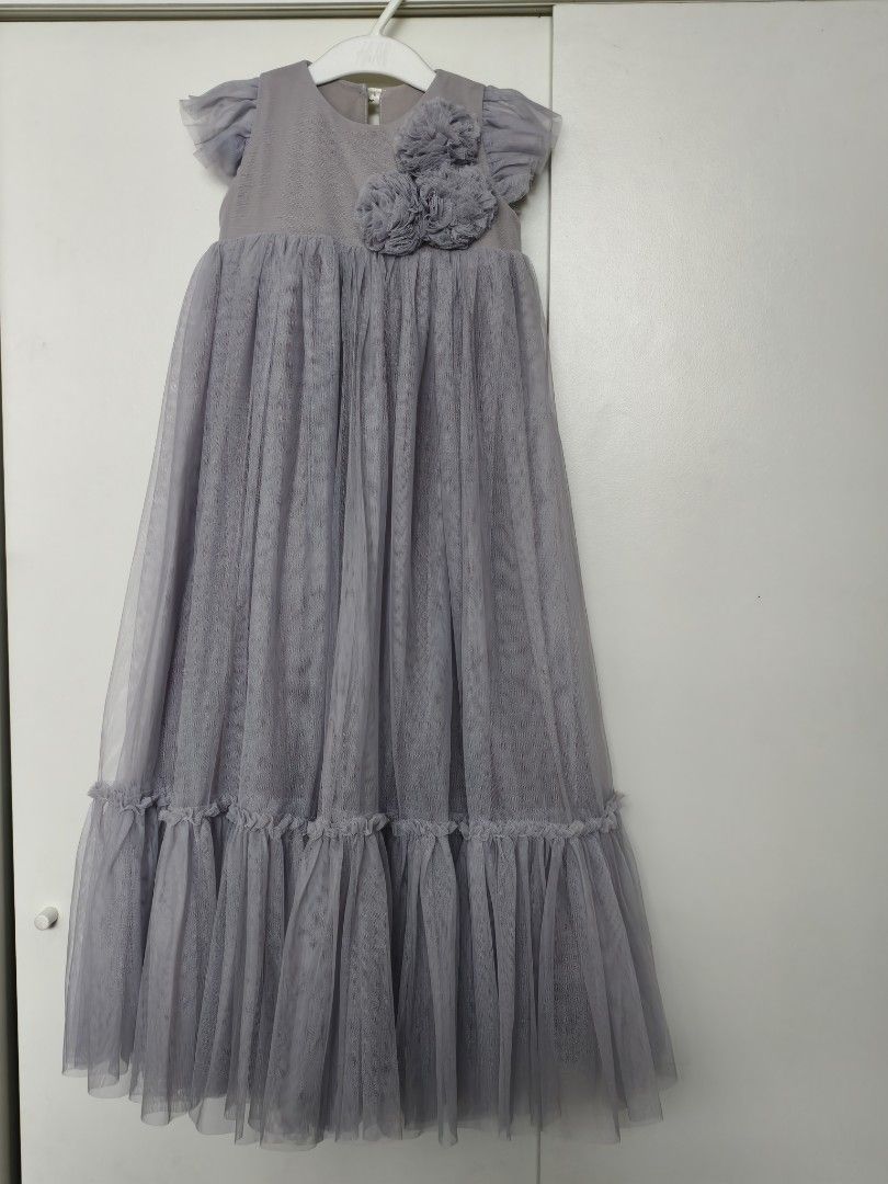 Spinkiewear Grey Tulle Dress (Category: Babies & Kids Fashion) located in Calamba. Submitted by junethomasb (Listing ID 1435219338, Image 1). Description: - Spinkiewear grey tulle dress - Size: 2/3 - Features: Round neckline, short flutter sleeves, floral embellishment - Design: Floor-length skirt with ruffled hem - Ideal for special occasions.