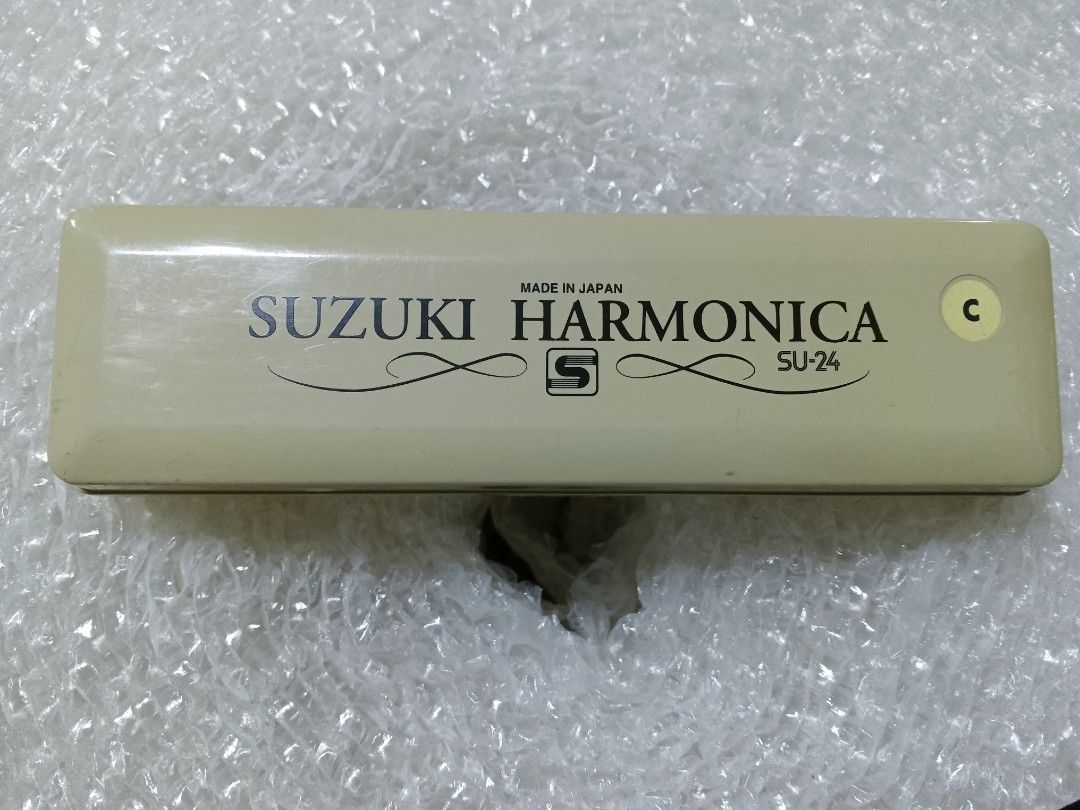 Suzuki Tremolo Harmonica SU-24 (Category: Musical Instruments) located in Baguio. Submitted by iyakoy (Listing ID 1435277434, Image 1). Description: - Suzuki SU-24 Tremolo Harmonica - Key of C - Includes original case and cleaning cloth - Silver harmonica - Beige case - 24-hole tremolo - Made in Japan.