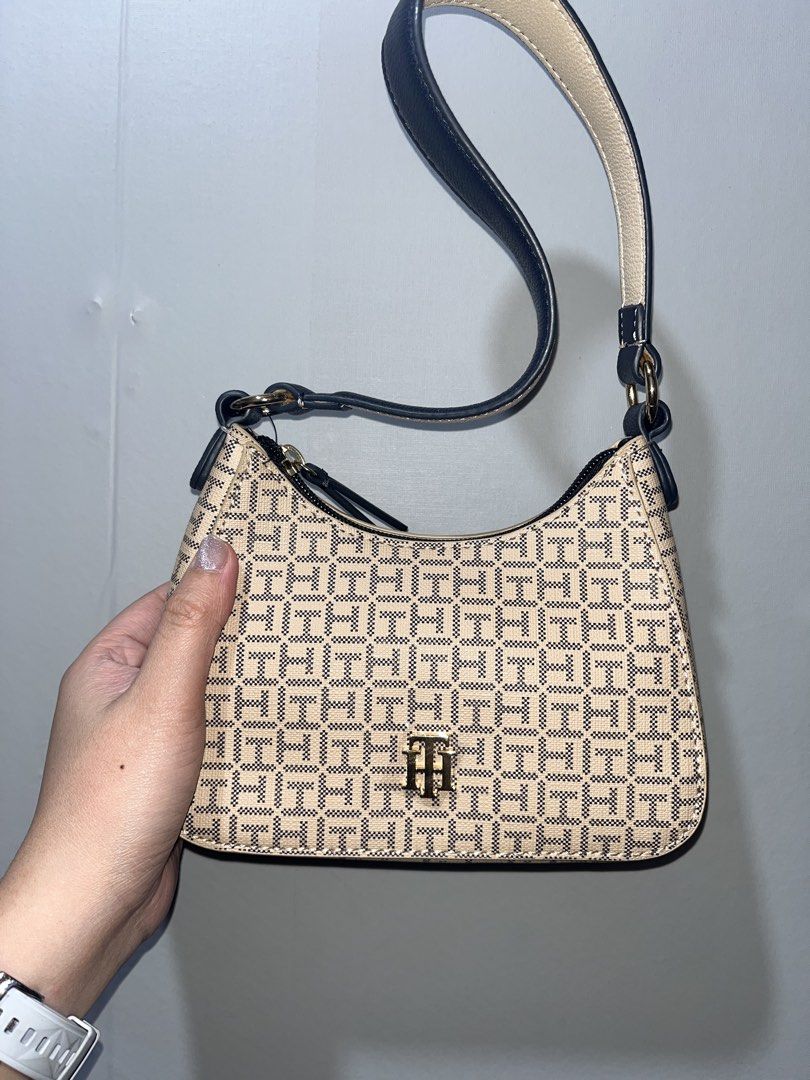 Tommy Hilfiger Shoulder Bag (micro kili bag) (Category: Shoulder Bags) located in Manila. Submitted by papapeyy (Listing ID 1409497651, Image 2). Description: - Authentic Tommy Hilfiger shoulder bag - New with original tags (price: $98) - Stylish beige and navy pattern - Features a top handle - Secure zipper closure - Beautiful floral interior lining.