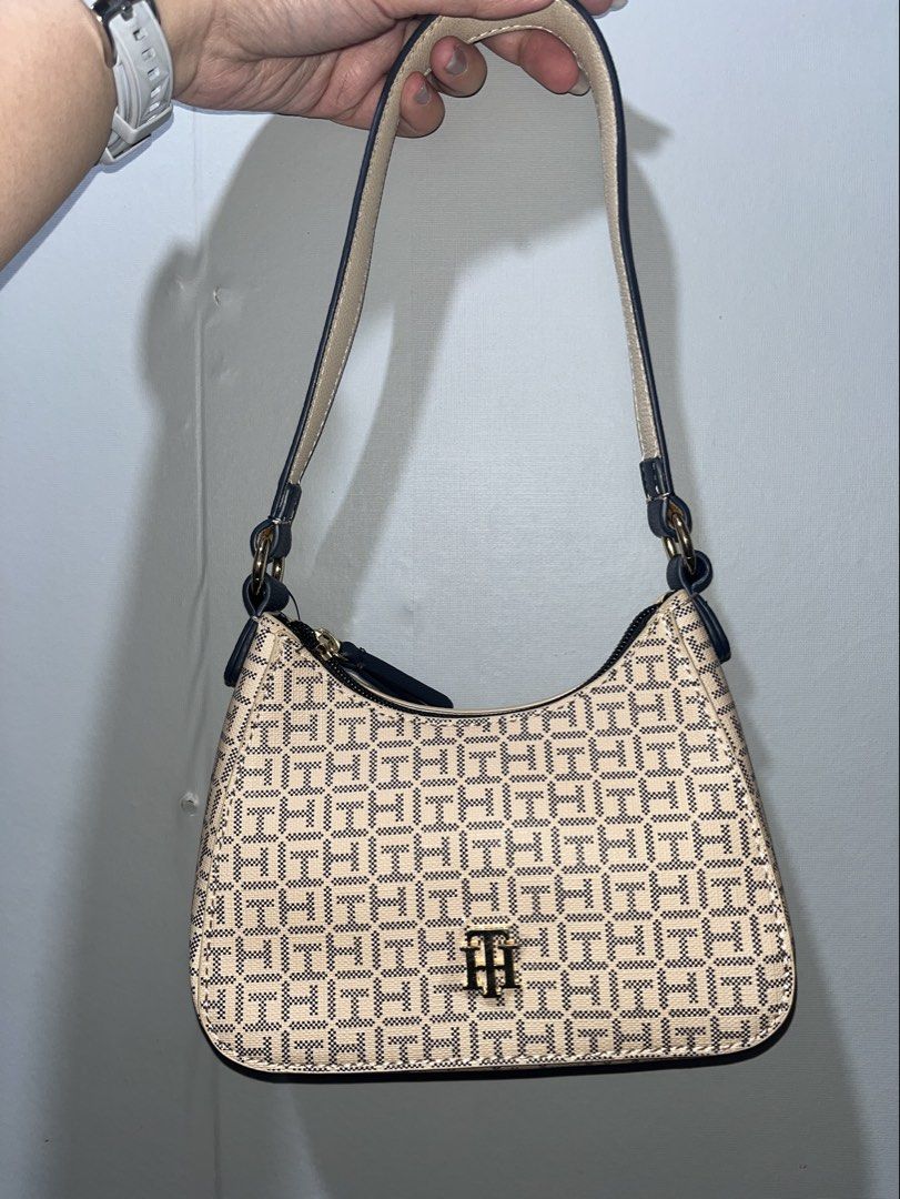 Tommy Hilfiger Shoulder Bag (micro kili bag) (Category: Shoulder Bags) located in Manila. Submitted by papapeyy (Listing ID 1409497651, Image 1). Description: - Authentic Tommy Hilfiger shoulder bag - New with original tags (price: $98) - Stylish beige and navy pattern - Features a top handle - Secure zipper closure - Beautiful floral interior lining.