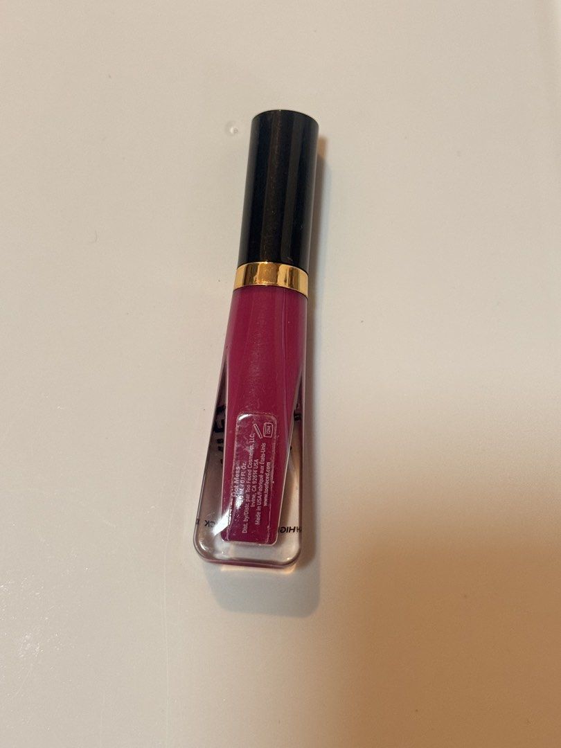 Too Faced Melted Latex Lipstick (Category: Makeup) located in Lucena. Submitted by fashioncult.ph (Listing ID 1435175565, Image 2). Description: - Authentic Too Faced Melted Latex Lipstick - Shade: Deep pink/berry - Packaging: Black cap with gold band, clear tube - Allows color visibility - Product name: "Melted Latex" printed on tube - Brand new.