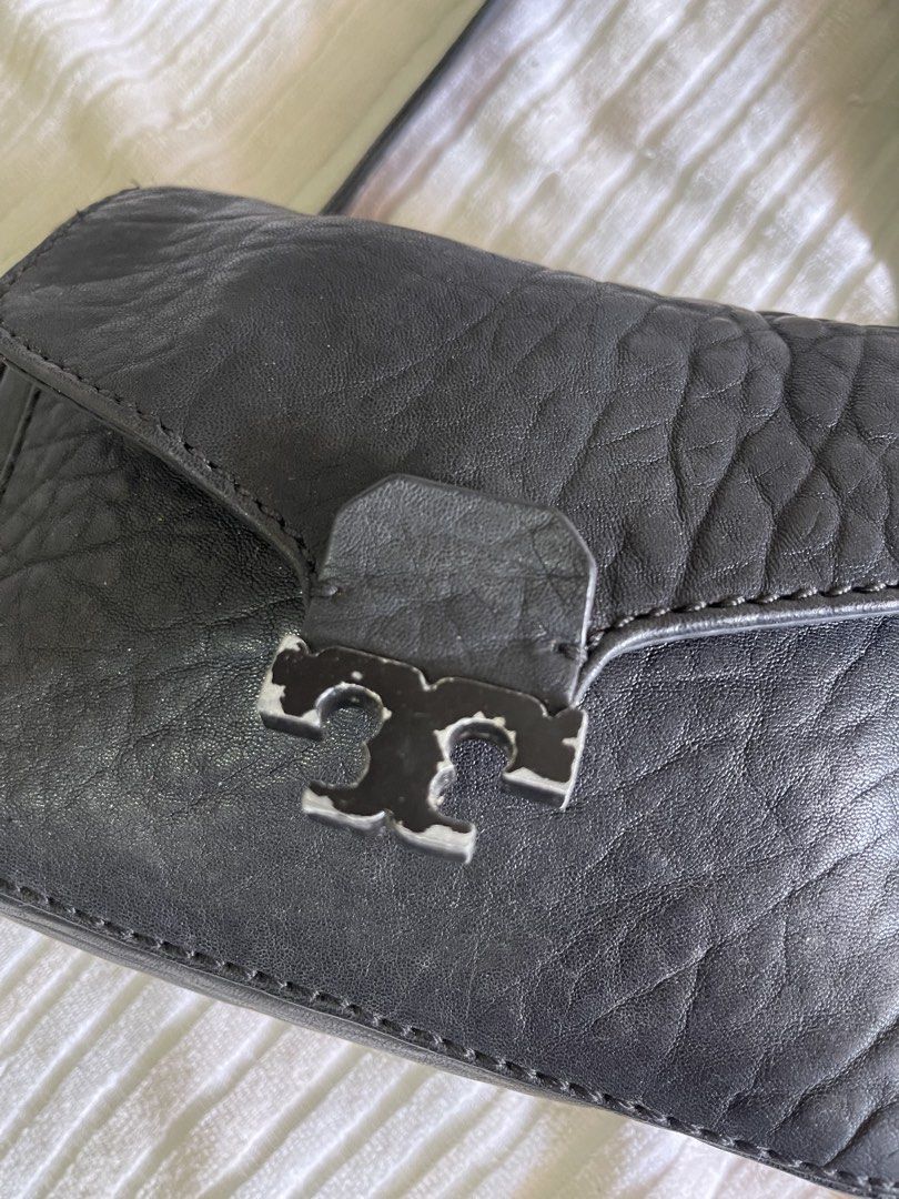 Tory Burch Black Crossbody Bag (Category: Luxury Bags & Wallets) located in San Pablo. Submitted by queenmomonline (Listing ID 1435178220, Image 2). Description: - Black crossbody bag - Flap closure - Gold chain strap - Tory Burch logo on front - Interior zipper pocket - Tory Burch logo lining - Textured leather exterior -Flaws: Tarnished T logo -Auth - 5x8x2.
