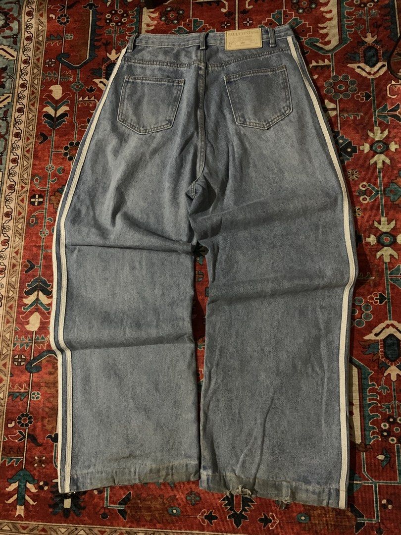 Vault Vintage Wide Leg Jeans (Category: Jeans) located in Cagayan de Oro. Submitted by chabermz (Listing ID 1435189980, Image 2). Description: - Vault Vintage wide-leg jeans - Light blue wash - White stripes on sides - Relaxed fit - Button and zipper closure - Two front and two back pockets - Vault Vintage label visible - Need wash Dimes W- 32 T- 14.5 L- 42 H- 11.