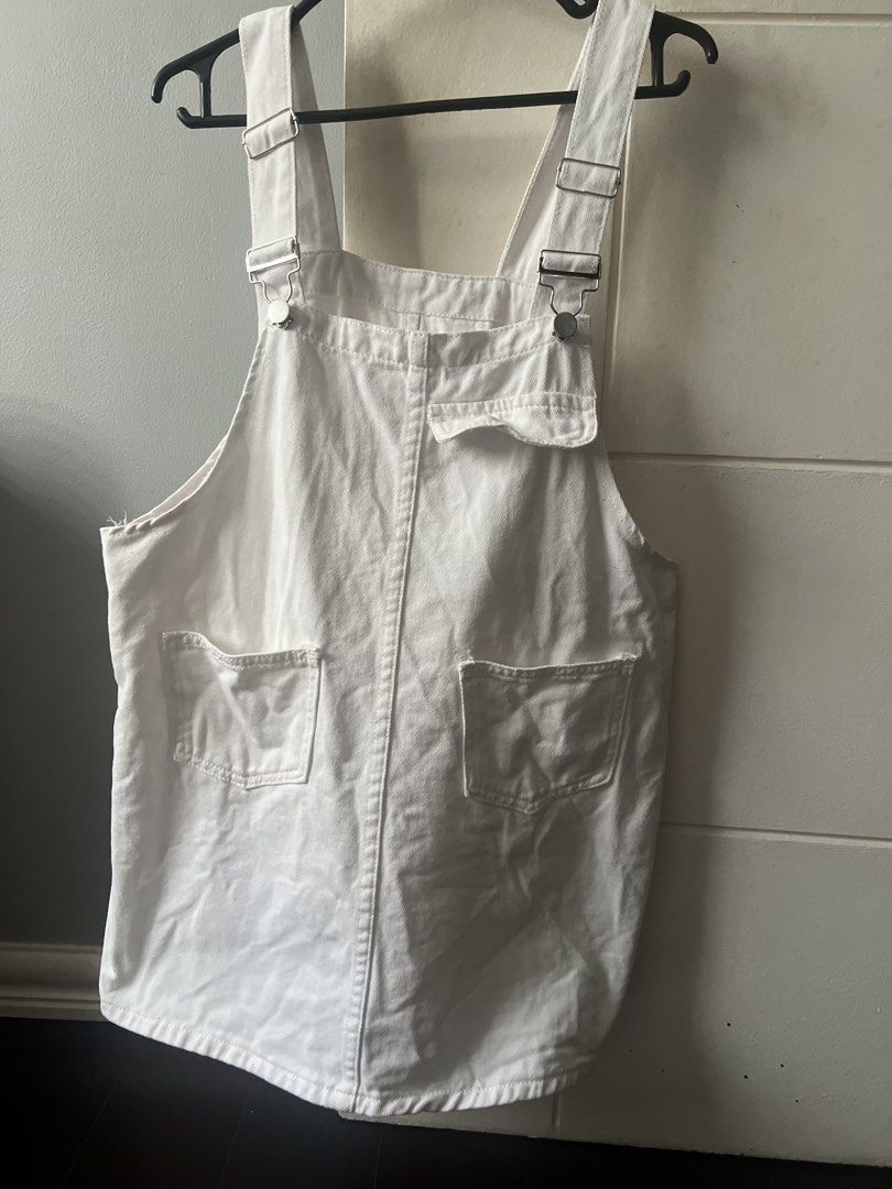 White Denim Overalls Dress (Category: Dresses) located in Marikina City. Submitted by prelovedreeses (Listing ID 1435177590, Image 1). Description: RFS: Decluttering Neckline to bottom lenght: 21.5 inches - White denim overalls dress - Adjustable straps with metal clasps - Square neckline - Relaxed fit - Two front pockets - Two back pockets - Perfect for a casual and stylish look.