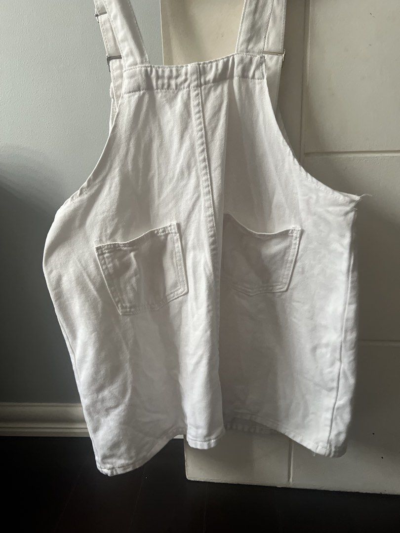 White Denim Overalls Dress (Category: Dresses) located in Marikina City. Submitted by prelovedreeses (Listing ID 1435177590, Image 2). Description: RFS: Decluttering Neckline to bottom lenght: 21.5 inches - White denim overalls dress - Adjustable straps with metal clasps - Square neckline - Relaxed fit - Two front pockets - Two back pockets - Perfect for a casual and stylish look.